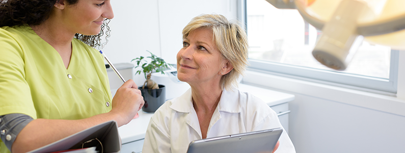 dental assistant listening to dentist