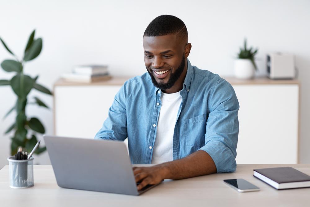 Man on computer, happy
