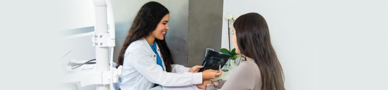 Dentist talking to patient in office