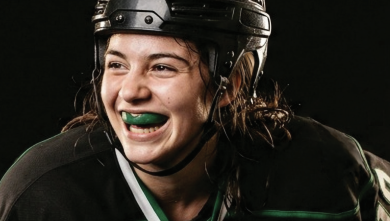 Female hockey player wearing Delta Dental mouthguard.