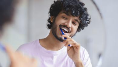 Happy man brushing teeth.